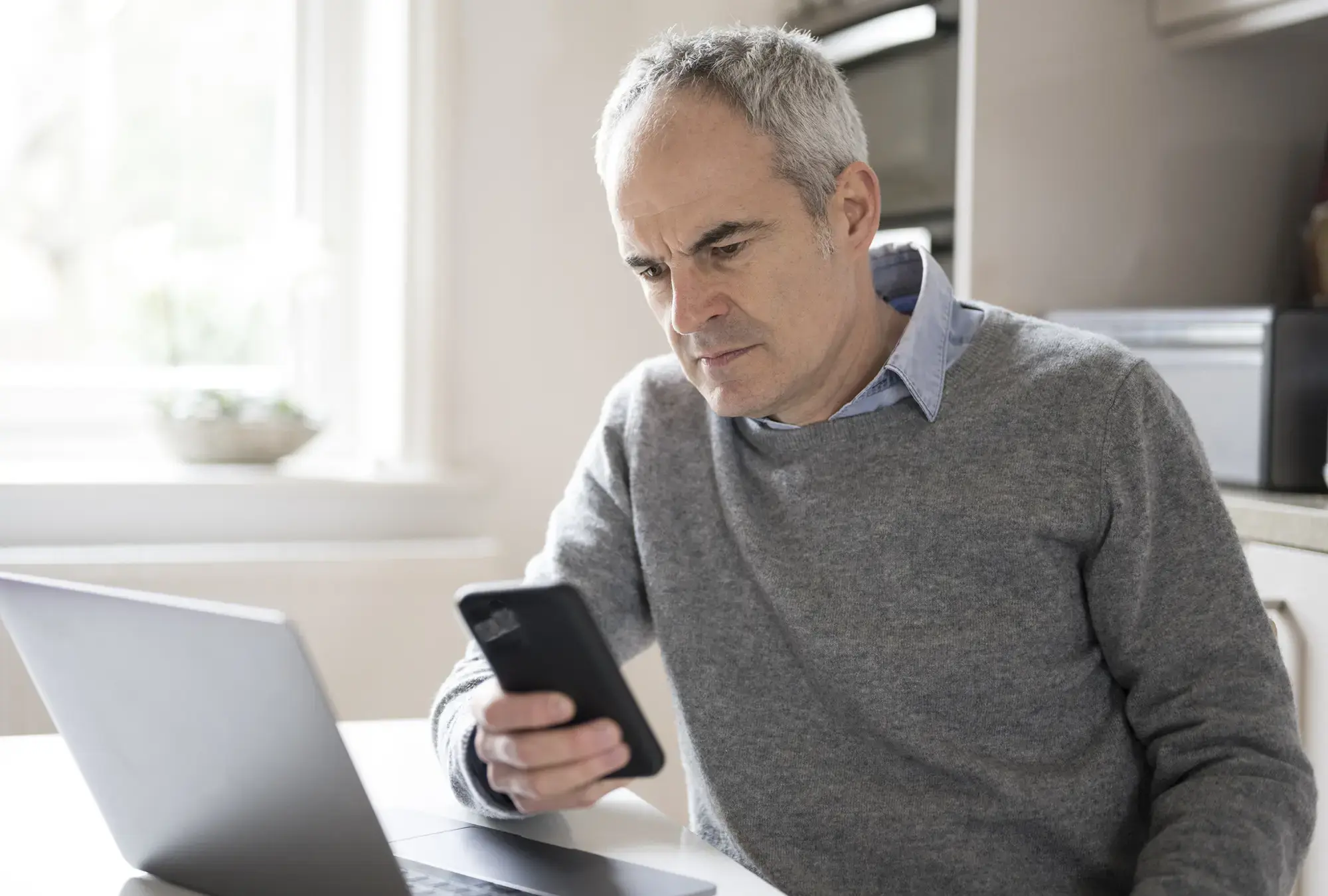 Concerned man looking at his phone