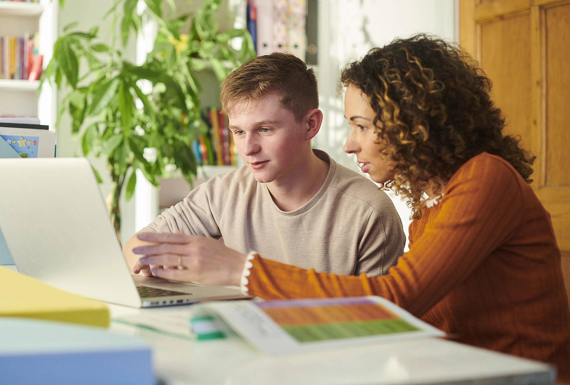 mom and son looking at computer