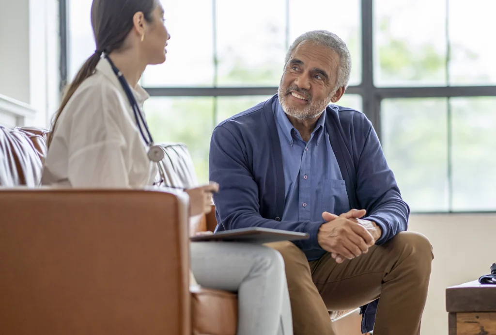 Older gentleman talking with doctor