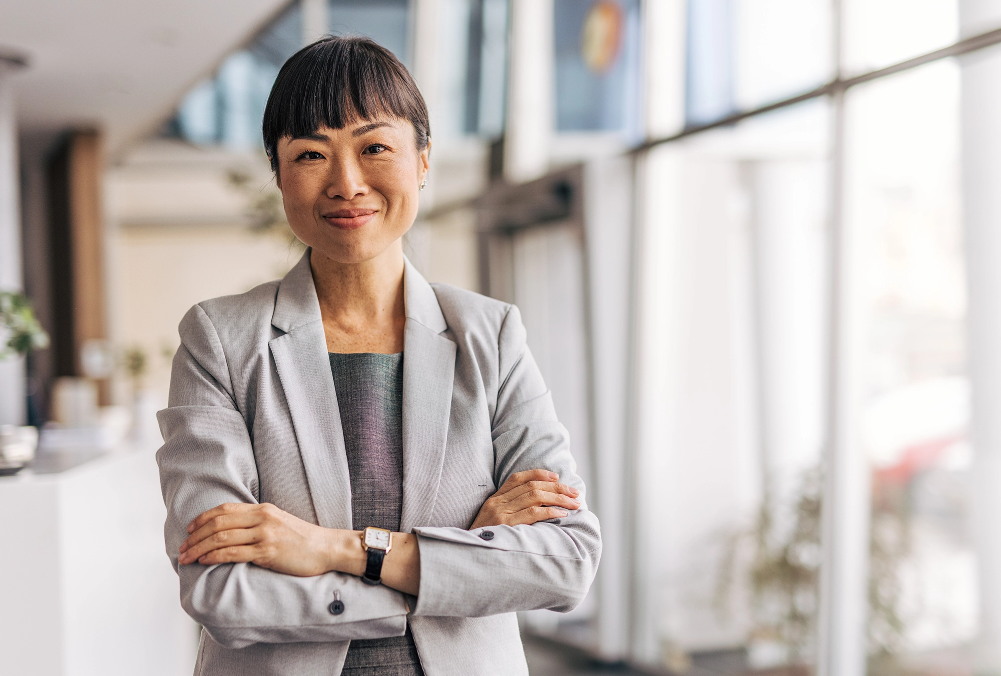 female business professional smiling with her arms folded